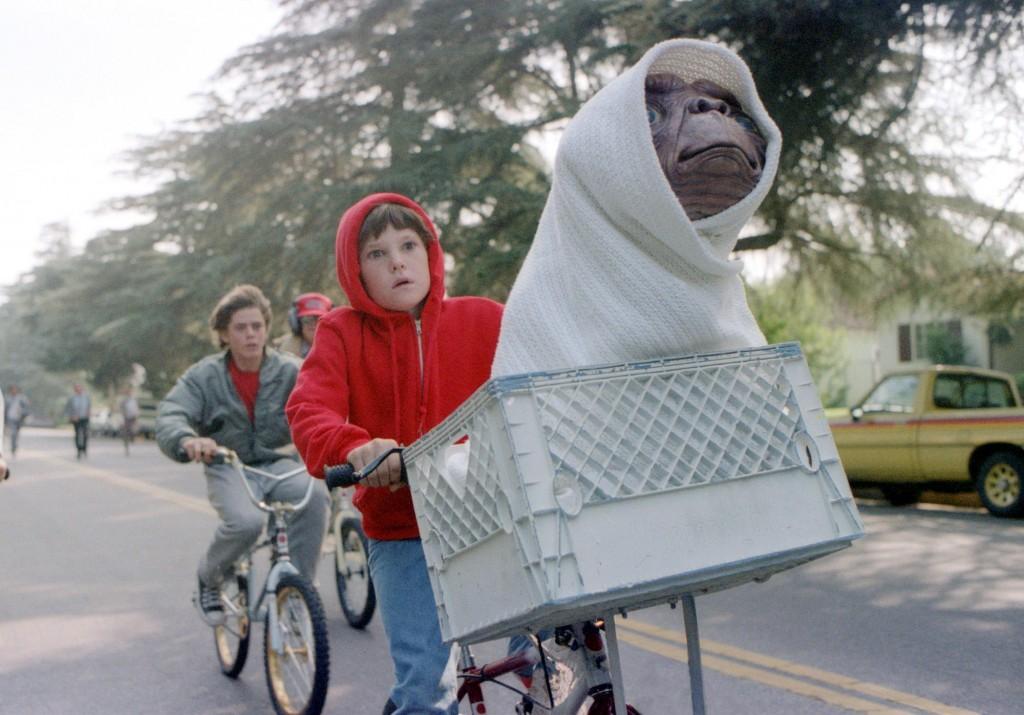 This undated studio handout shows Elliott, played by Henry Thomas, his brother and friends riding as fast as they can from the police to get "E.T. The Extra-Terrestrial" back to the forest. Steven Spielberg's 1982 "E.T. The Extra-Terrestrial" returns to theaters Friday, updated with a couple of previously unreleased scenes, visual enhancements, improved sound and excisions that have annoyed some purists who dislike tampering with beloved films. (AP Photo/Bruce McBroom, Universal Studios Amblin Entertainment)