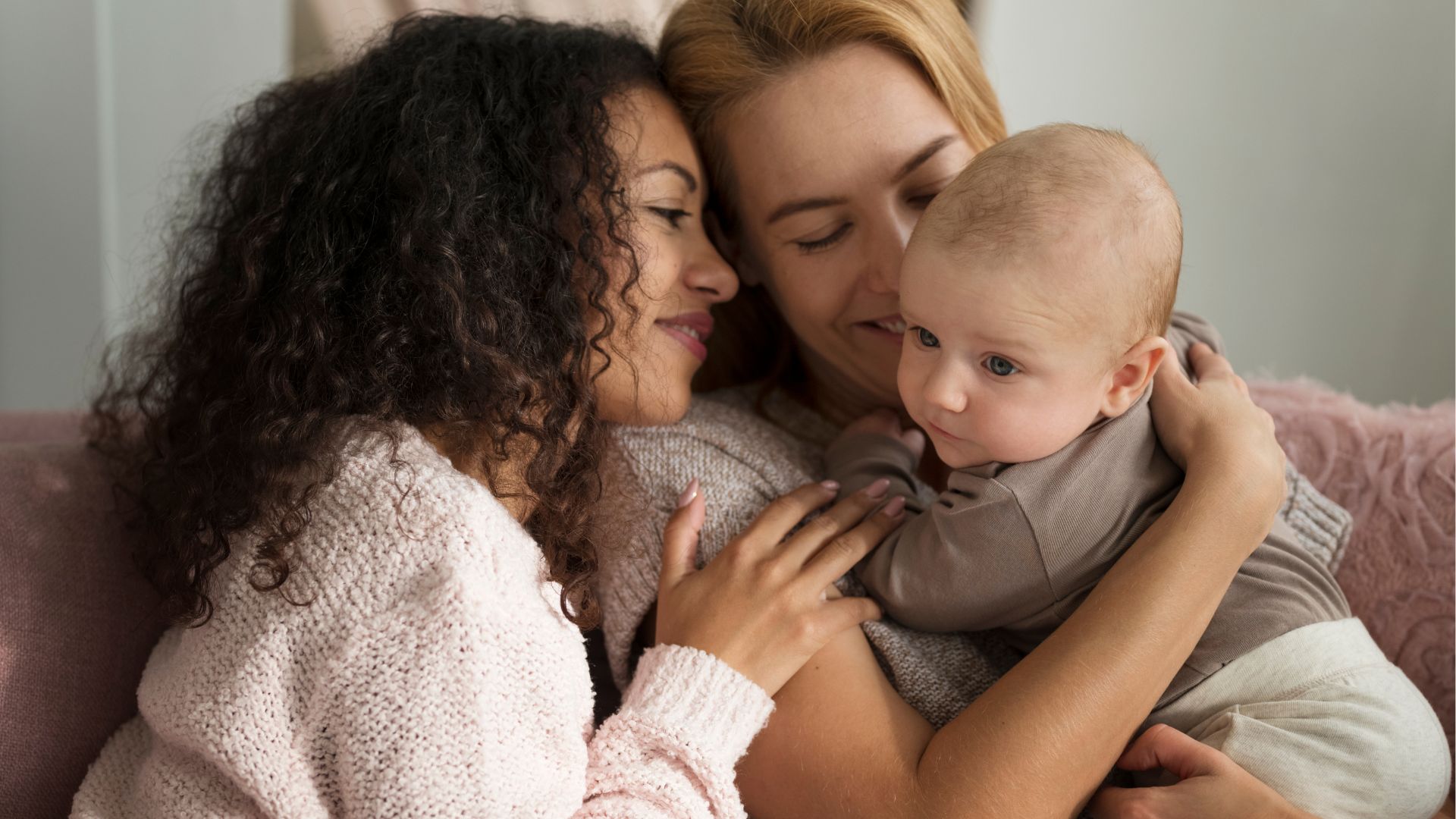 duas mães segurando um bebê