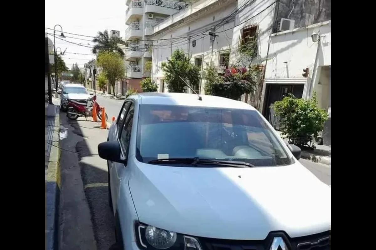 Carro na rua com bilhete colado