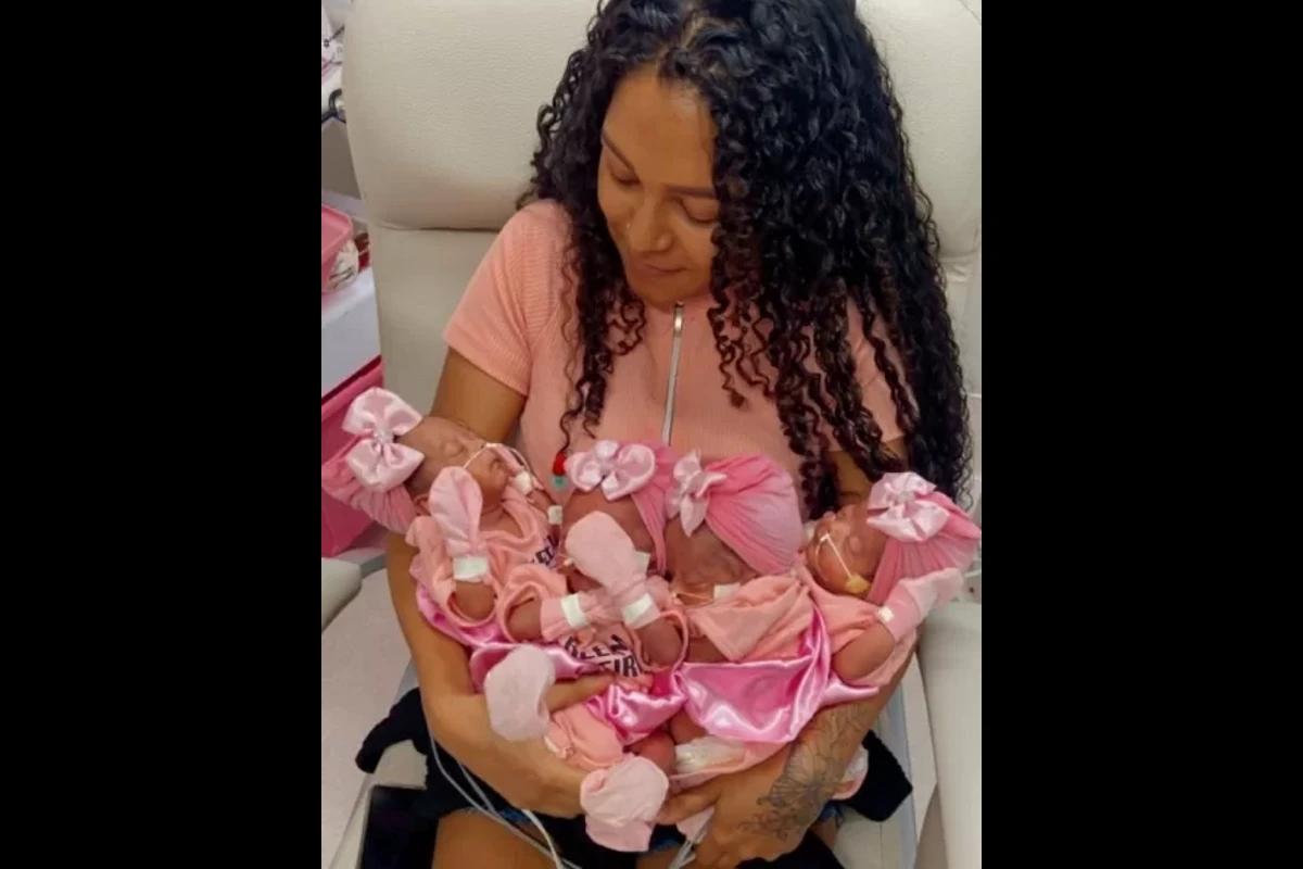 Mulher com bebês no colo