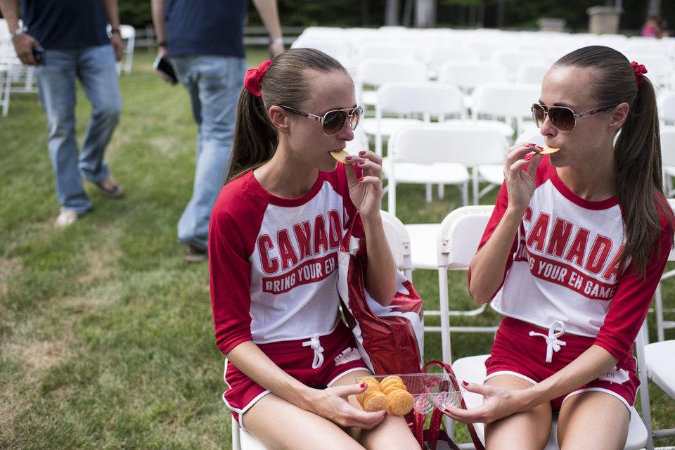 Allison, left, and Lauren Knight, 32 of Windsor, Ontario, share crackers with each other at the Twins Days Festival in Twinsberg, Ohio. Photo by Dustin Franz