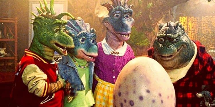 Personagens de Família Dinossauros olhando para um ovo.