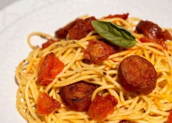 Prato de macarronada com linguiça calabresa.